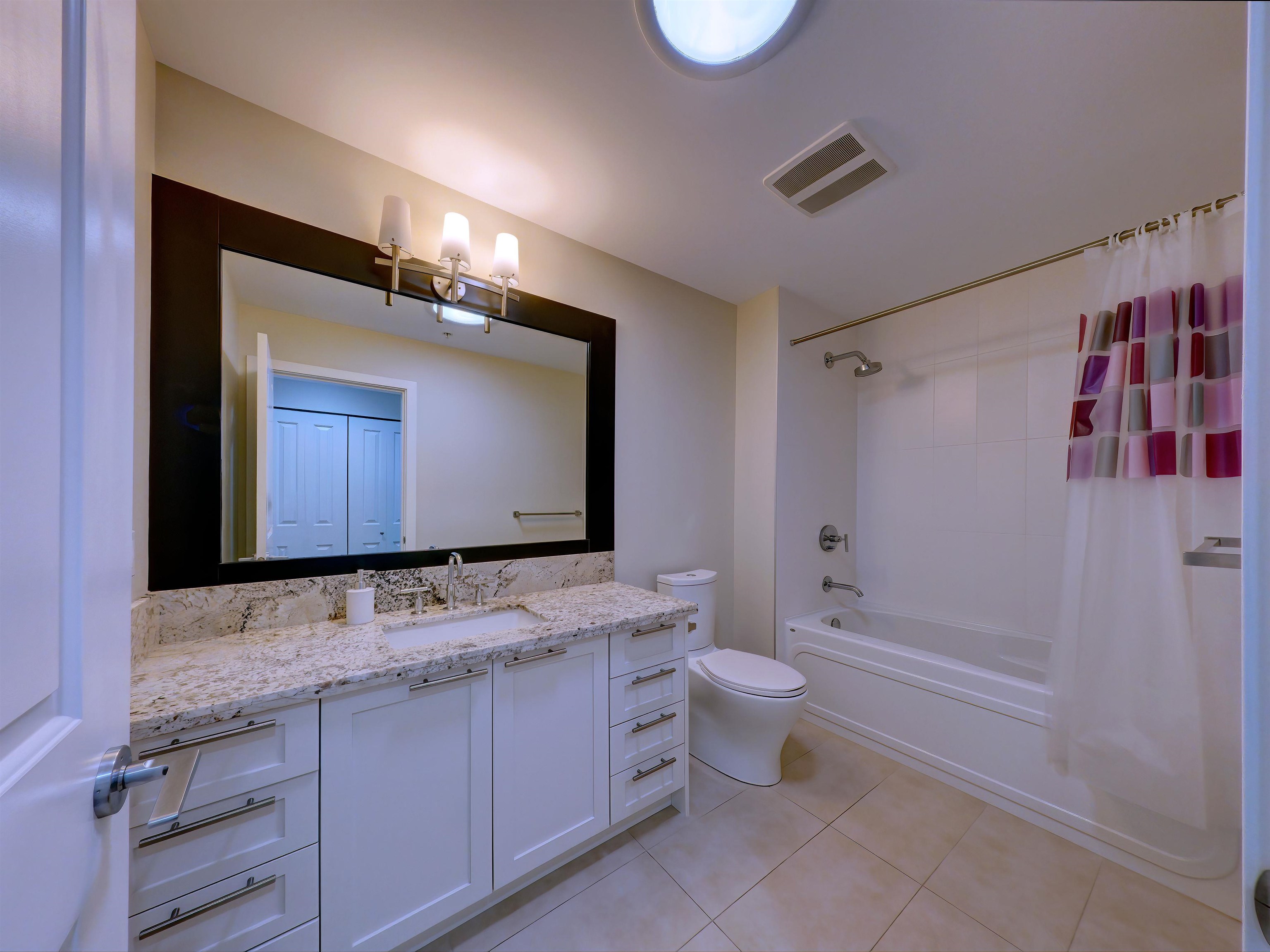 Main bathroom features tub/shower combination, elegant granite counters, tile flooring and a feature Sun Tunnel skylight for all day natural light!