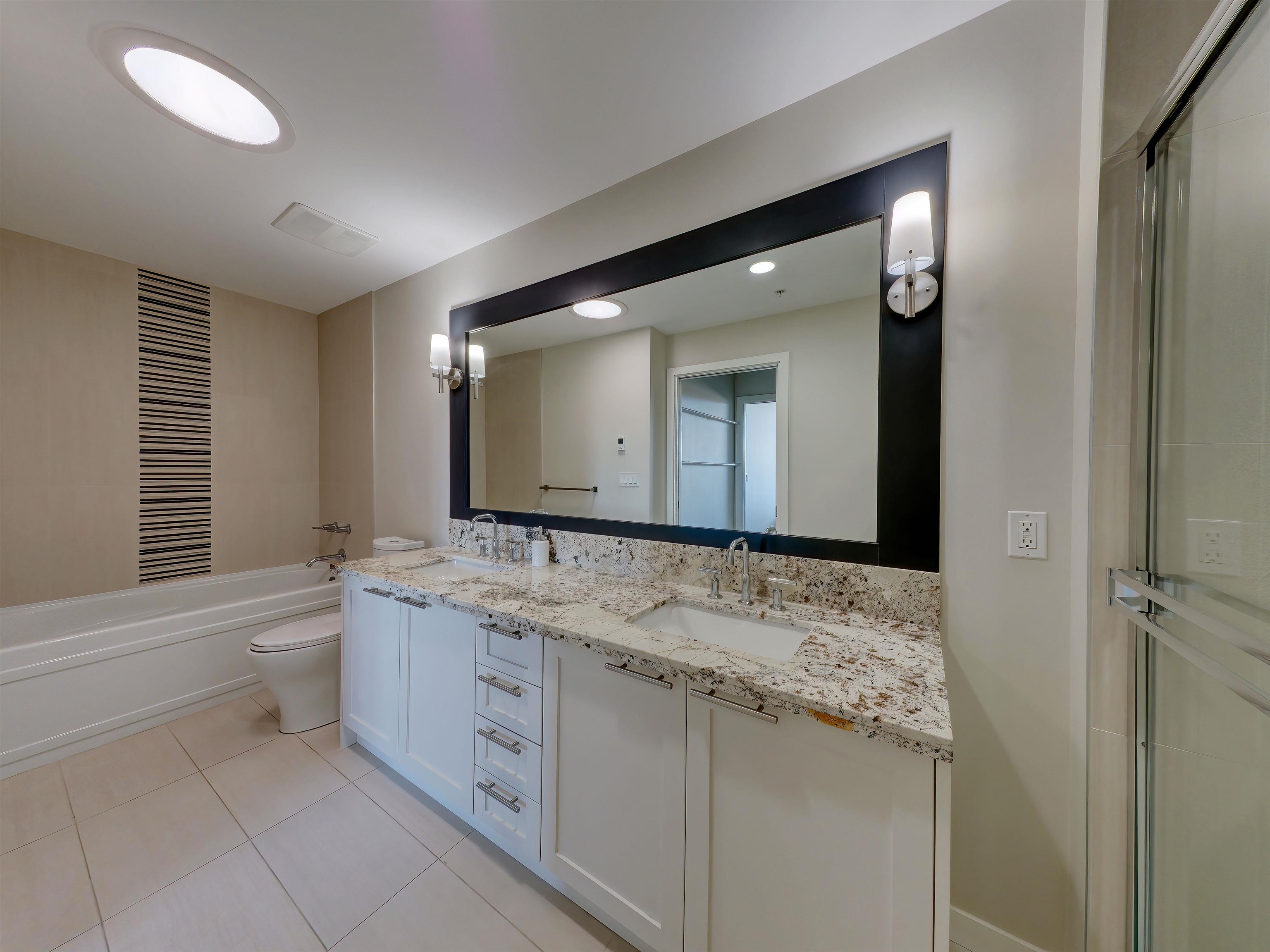Elegance says it all! This spa inspired en-suite offers double sinks, tiled floor, granite counters, Sun Tunnel Skylight and a large walk-in shower for ease of accessibility.