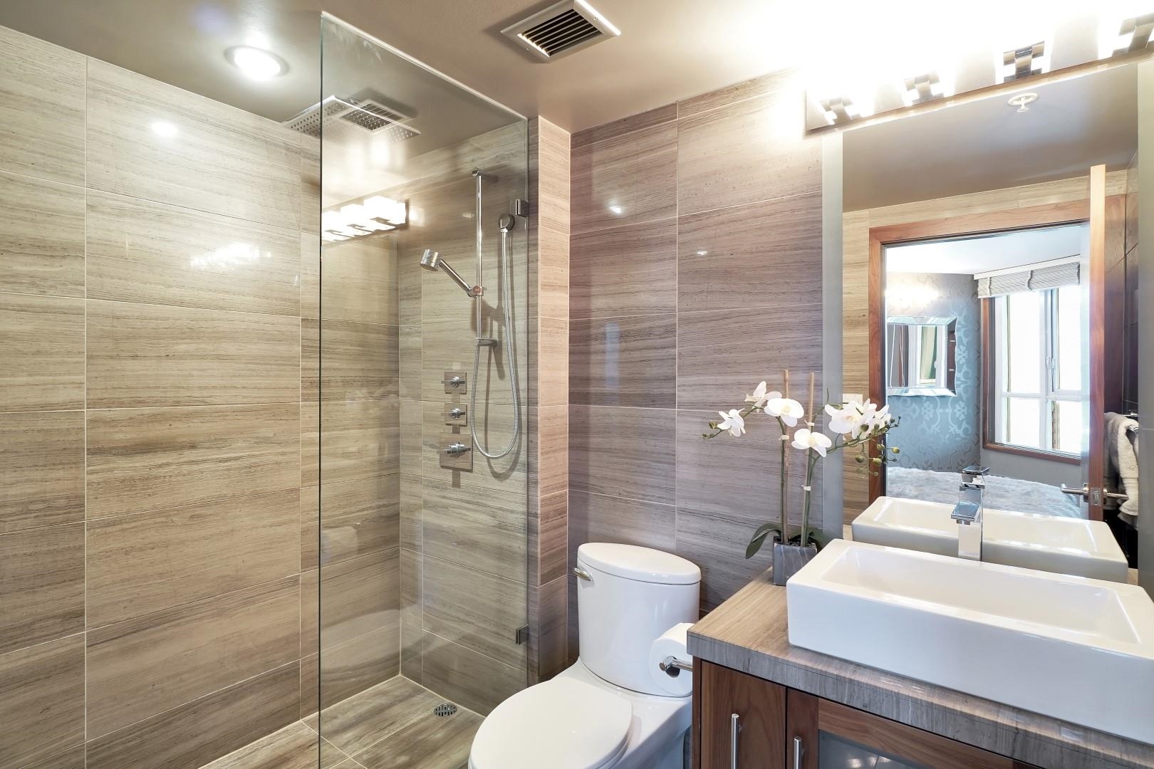 Travertine tile, double glass shower, Rain shower head and handheld shower head.