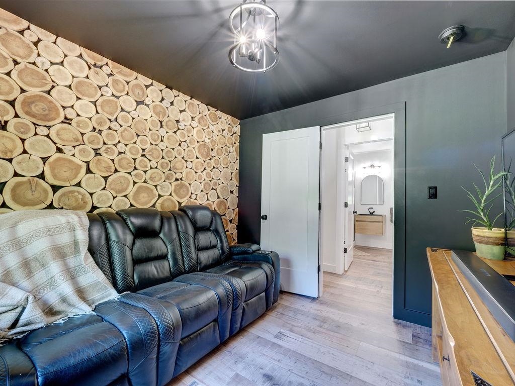 Currently set up as a media room, it has a closet so also can be a bedroom. The feature wall is made with local wood disks which the homeowners put together themselves!