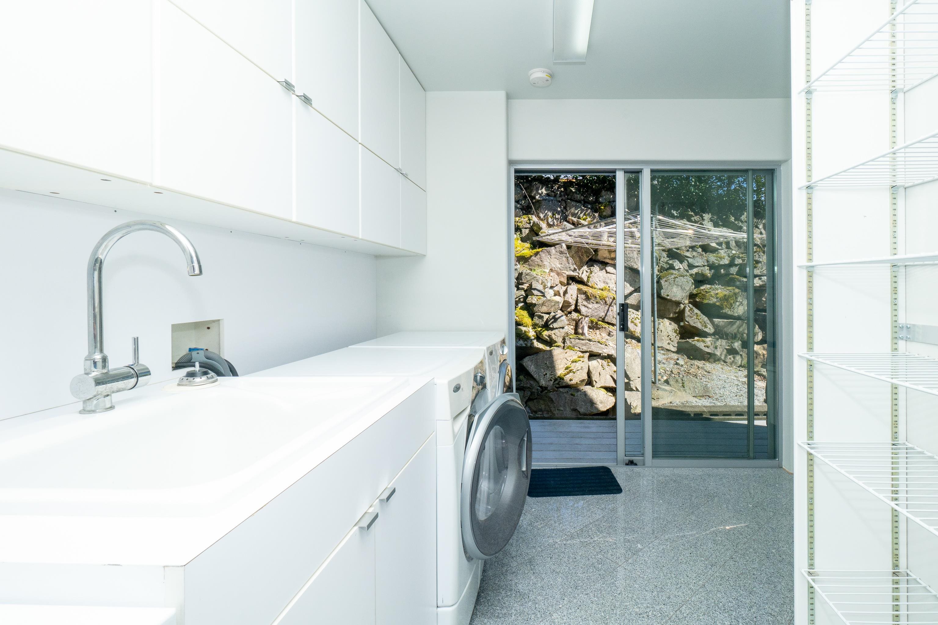 This room situated off the kitchen features storage, a extra fridge and freezer as well as laundry and drying area. There is a laundry shoot from the primary bedroom walk in closet that shoots right into a basket in this room for a easy laundry day
