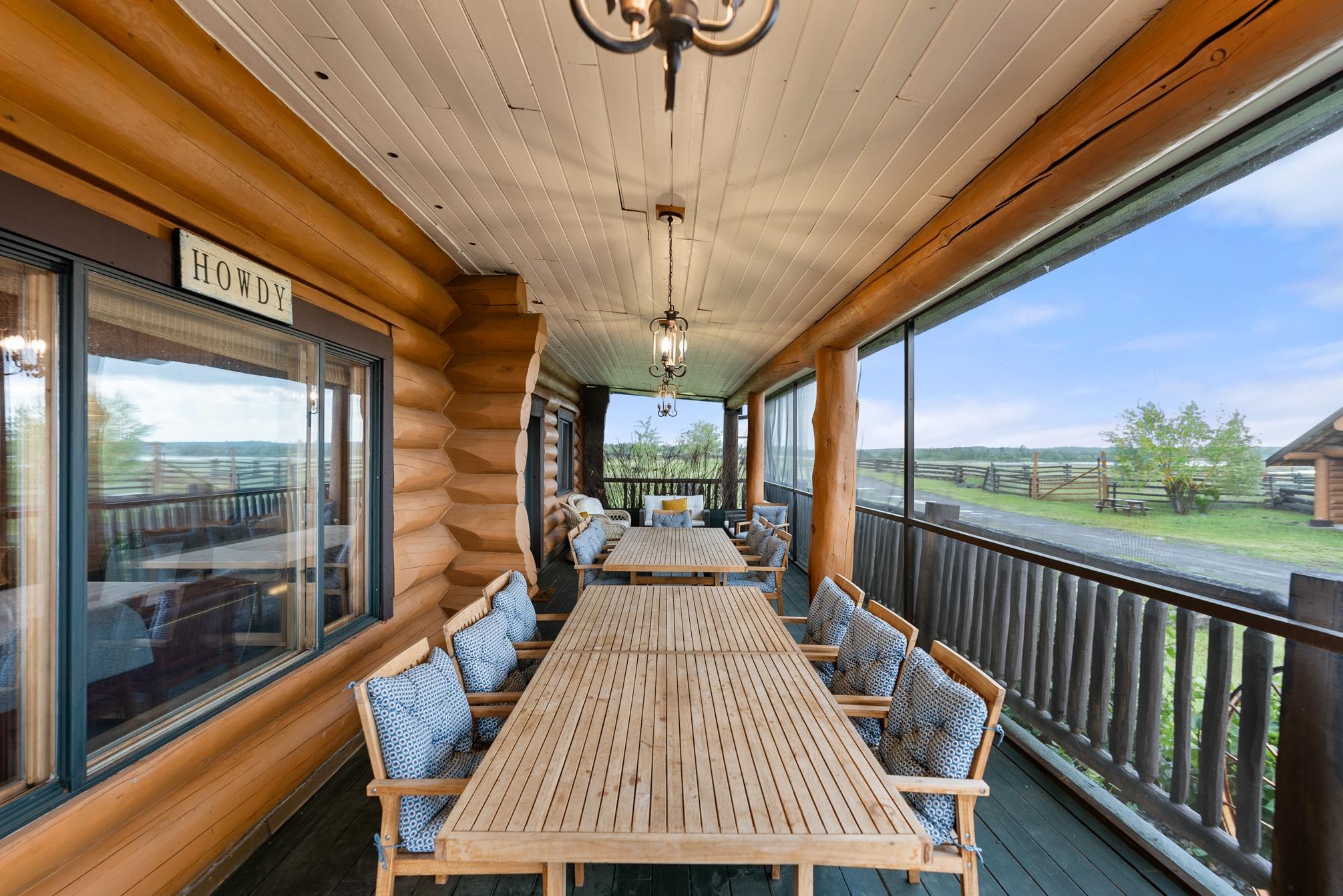 Ranch House Front porch. Fully screened. Dining Table for 16 people + sitting area.