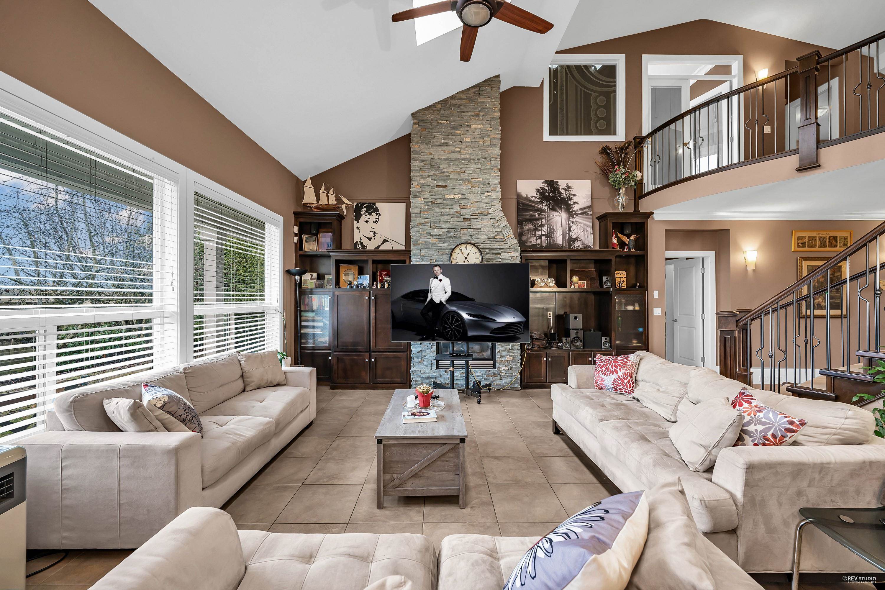 LR with vaulted ceilings, fireplace, skylights and large south facing windows