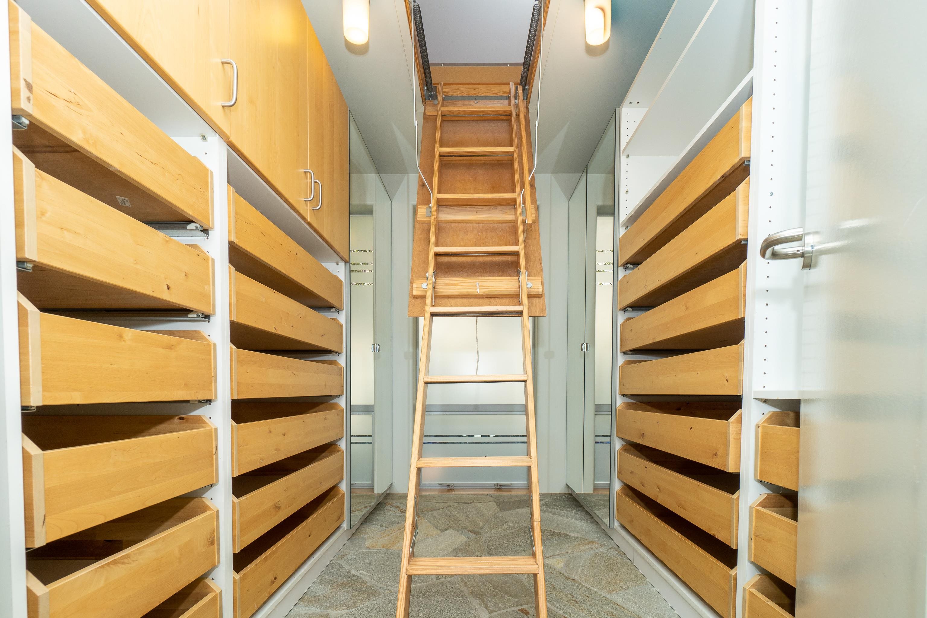 Custom walk in closet with laundry shoot and pull down attic stairs