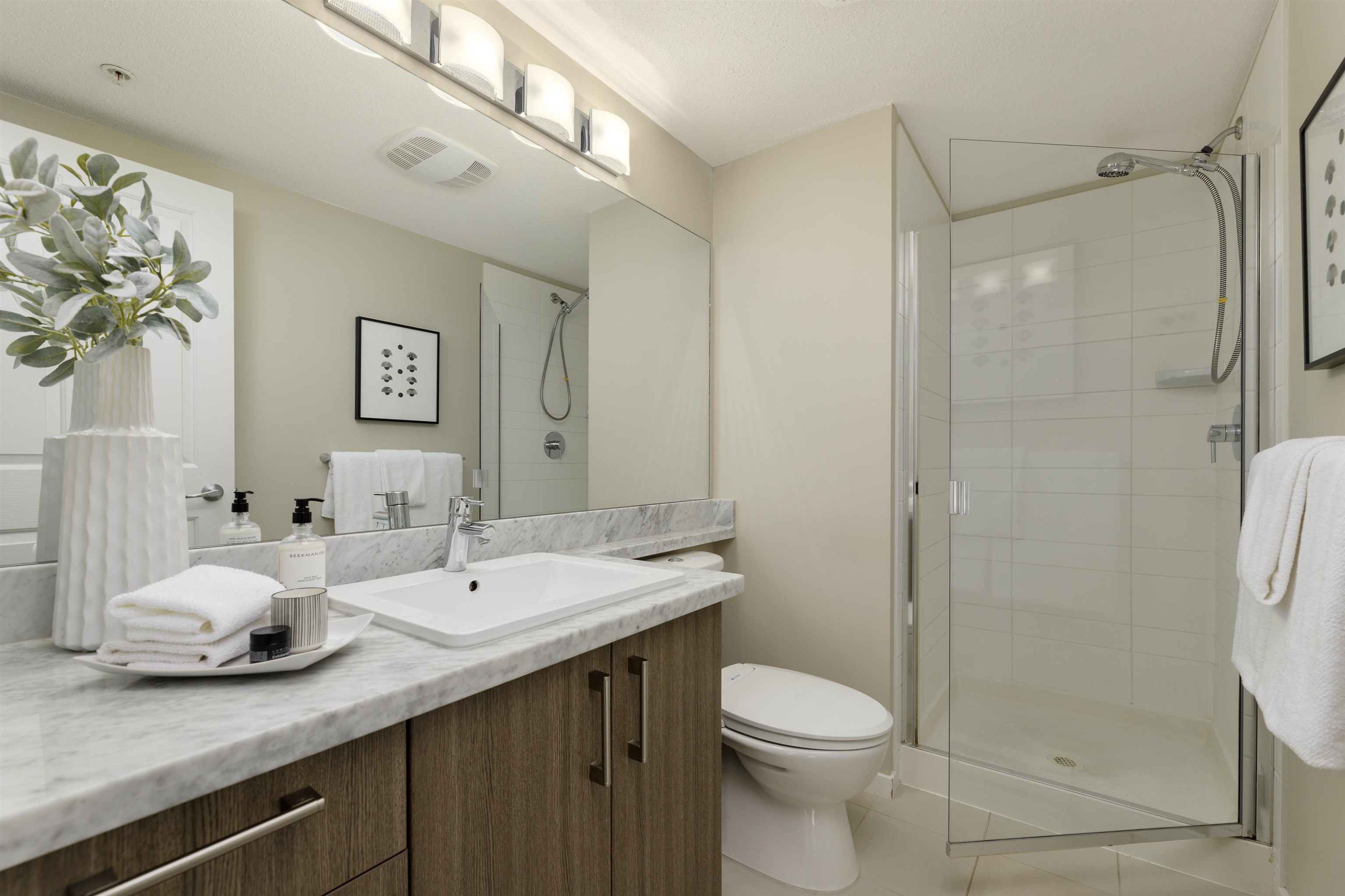 Secondary bathroom has plenty of counter space and storage.