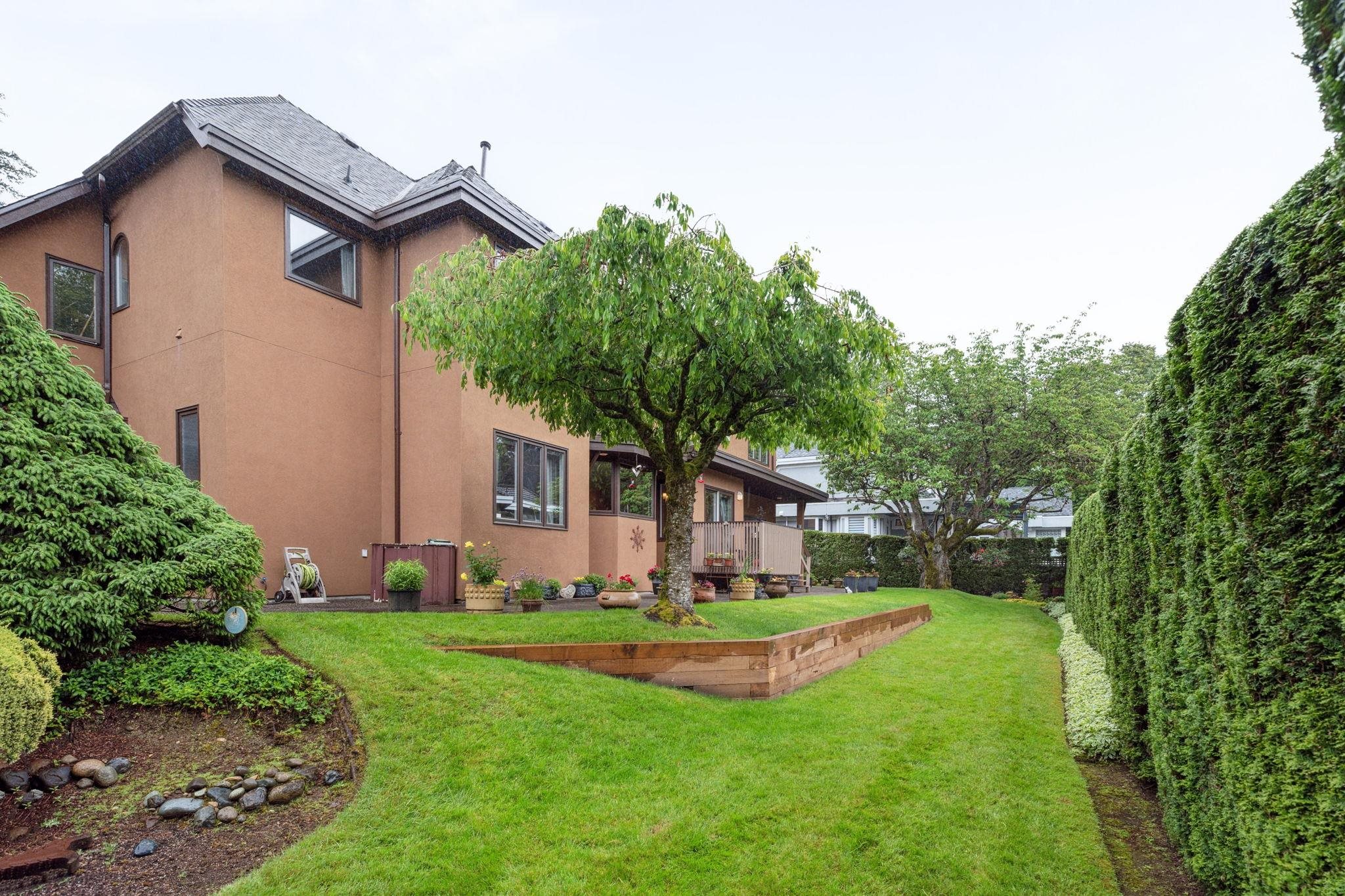 Mature garden blooming with plants, flowers and trees.